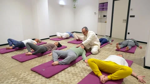 Instructor leading a breathing exercise in a Qi gong class Stock Footage 267542403