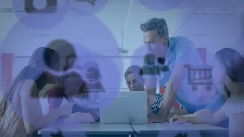 Instructor leaning forward, guiding students at laptop, typing and pointing at Stock Footage 330540314