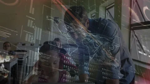 Instructor leaning over student desk initiating map and chart overlay while Stock Footage 311507657