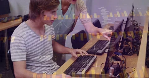 Instructor leaning over student, pointing at screen, guiding typing for class Stock Footage 328417745