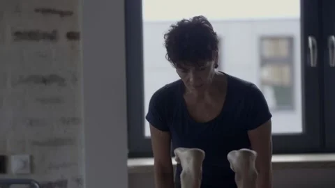 Instructor looks at how the student performs the exercise and prompts something Video stock 102547552