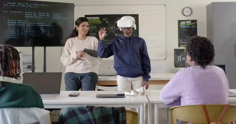 Instructor nodding, class watching teen with VR headset reaching and pinching Stock Footage 341029508