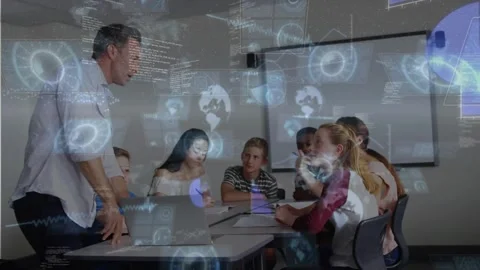 Instructor opening laptop and teaching tech in class, students writing, HUD 스톡 동영상 321121407