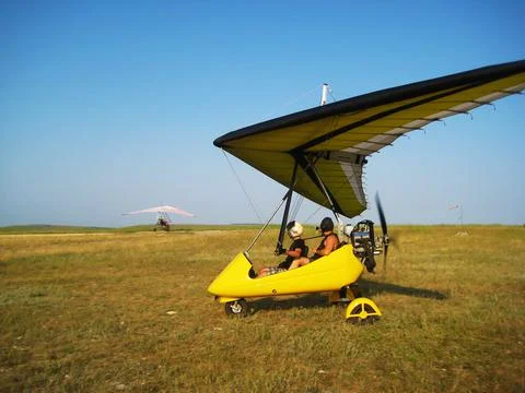 The instructor pilot and passenger sit in a hang glider Stock Photos