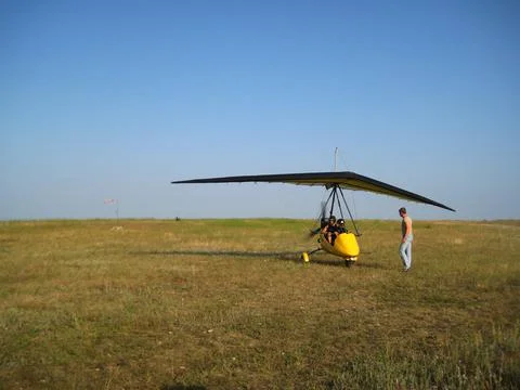 The instructor pilot and passenger sit in a hang glider Stock Photos