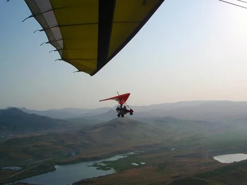 The instructor pilot and passenger sit in a hang glider Stock Photos