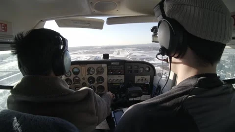 Instructor Pilot and Student Land on Runway - Rear View Cockpit Stock Footage 311679614