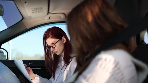 Instructor reviews checklist student fastens seat belt Video stock 332872043