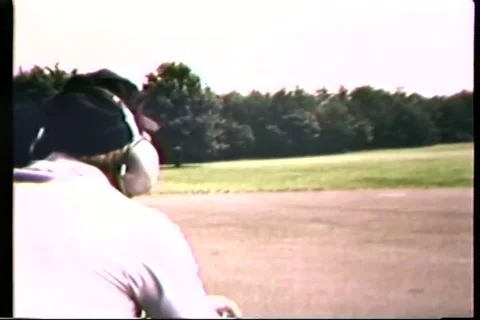 Instructor shoot target with pistol in open field - 1965 Stock Footage 106067494