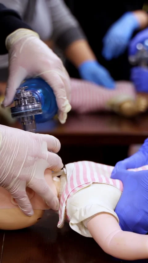 Instructor showing CPR on training doll. Stock Footage 303442500