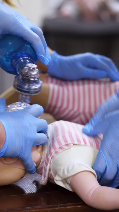 Instructor showing CPR on training doll Stock Footage 303442502