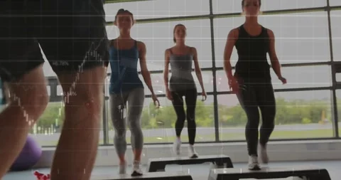 Instructor showing stepping from left, leading three women mirroring on step Stock Footage 331272980