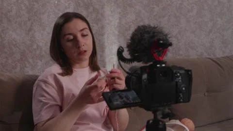 Instructor showing yarn materials for an online knitting course Stock Footage 337452076