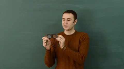 Instructor shows protective working glasses, explains functional application. Stock Footage 68685447