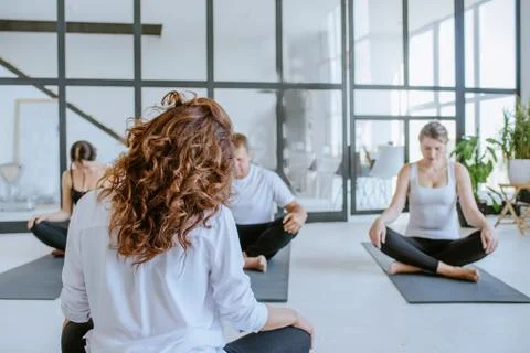Instructor sitting back with group of young people Stock Photos