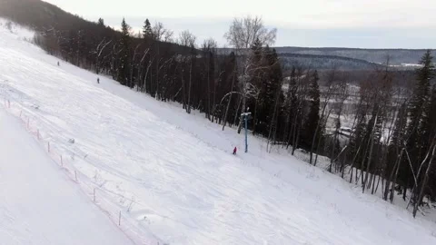 The instructor of the ski school helps the student to climb on the lift. Stock Footage 148424643