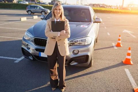 Instructor Standing by Learner Car with L Plate and Traffic Cones Stock Photos
