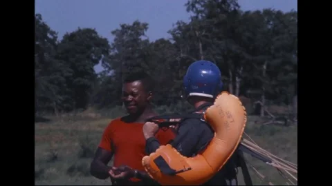 Instructor talking to astronaut before parasail training - 1968 Stock Footage 104331131