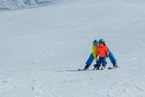 Instructor teach boy glide behind hold ski bindings with hands Stock Photos