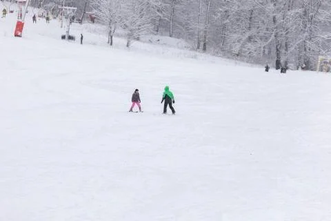 Instructor teaches a child to ski Stock Photos