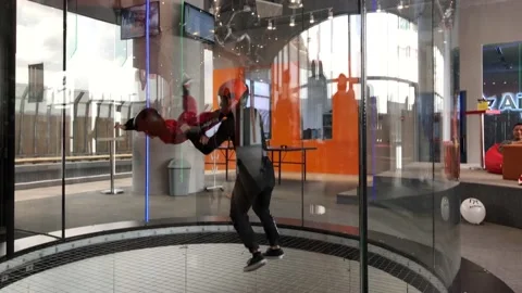 Instructor teaches indoor skydiving Stock Footage 109322216