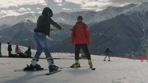 The instructor teaches the skiers on the mountain. Stock Footage 124369315