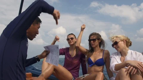 Instructor Teaching Diving Sign Language To The Girls Before Dive Stock Footage 125678648