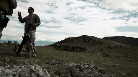 Instructor teaching soldiers on mortar range; panning right. Stock Footage 52702909