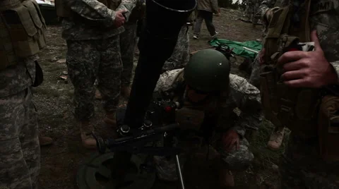 Instructor teaching soldiers on mortar range; handheld shot. Stock Footage 52702917
