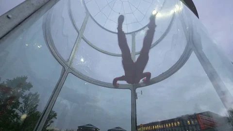 Instructor teaching young woman skydiving. Extreme parachuting in wind tunnel Stockbeeldmateriaal 82248703