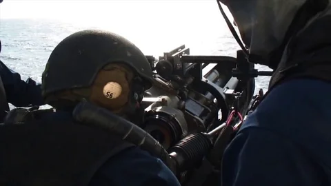 The instructor tells the soldier how to aim with Mark 38 Stock Footage 121025679