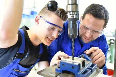 Instructor with trainee at drill machine Stock Photos