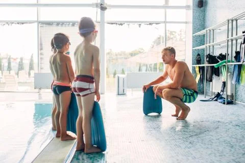 Instructor training children in the pool Stock Photos