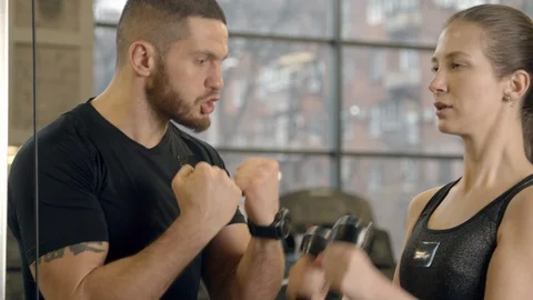 Instructor yelling at woman while working out in gym Stock Footage 125533871