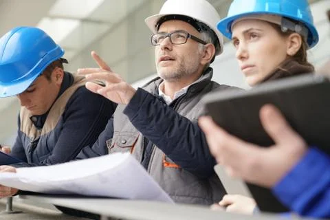 Instructor with young people in engineering training Stock Photos