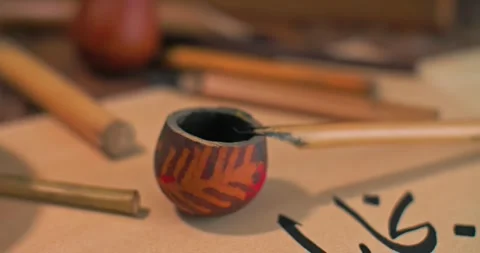Instruments of the Arabic caligraph on the table next to the letter. Stock Footage 277873086