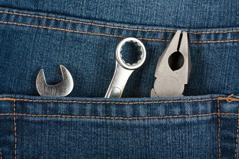 Instruments in the pocket of blue jeans Stock Photos