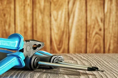Instruments set with screwdriver and pliers on the wooden display Stock Photos