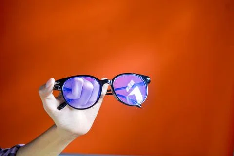 Insulated glasses with black frames. The background is orange Stock Photos