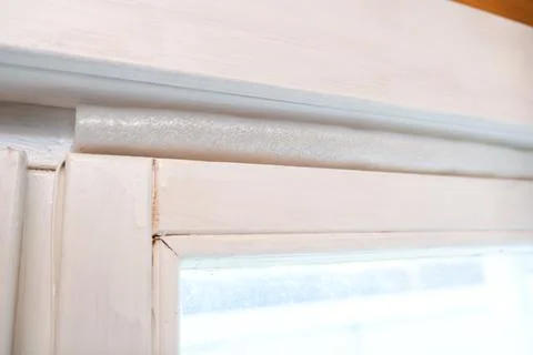 Insulated old window frames to prevent warmth heat leak and drafts, preparing Stock Photos