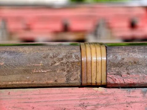 Insulating track pad secured by red clip isolates rails electrically at joi.. Stock Photos