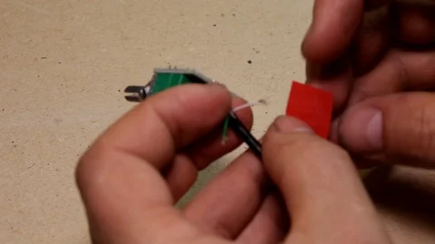 Insulating the wire with red electrical tape, close-up Video stock 90868622