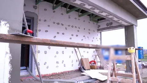 Insulation fixings visible on unfinished house wall during exterior renovation Stock Footage 313173309