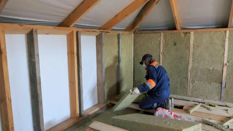 Insulation of a frame house with mineral wool. Cutting, fitting, laying 스톡 동영상 330493738