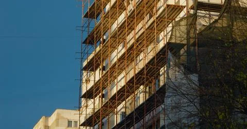 Insulation work in progress on a high-rise building with scaffolding 写真素材