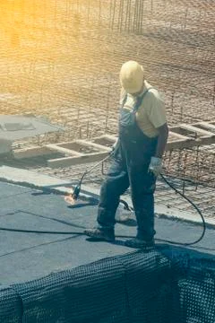 Insulation worker with blowtorch Stock Photos