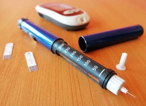 Insulin pen with needle tip, meter device and test strip for diabetics. Stock Photos