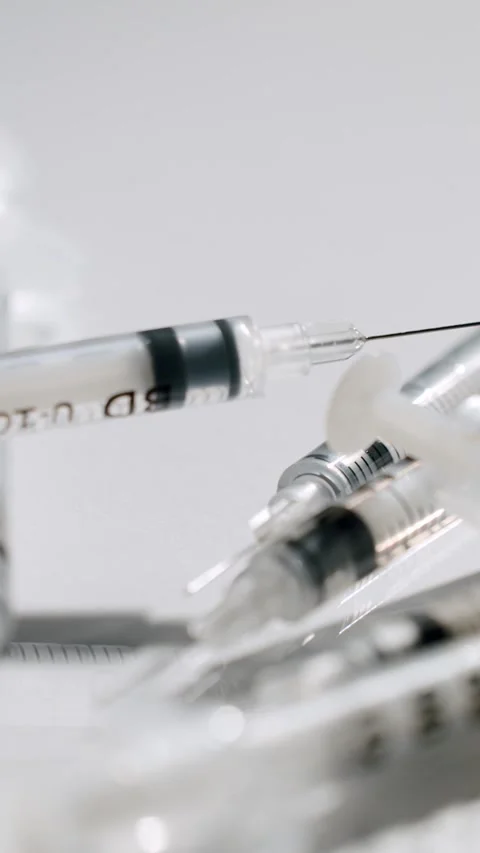 Insulin syringes rotating on a white background Stock Footage 329292799