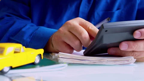 Insurance agent hands using calculator at desk close up. Stock Footage 337671437