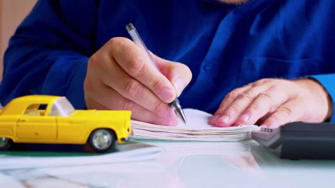 Insurance agent hands writing data in policy document at desk Stock Footage 337671186